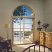 Interior photo of sliding patio doors with grids and arch