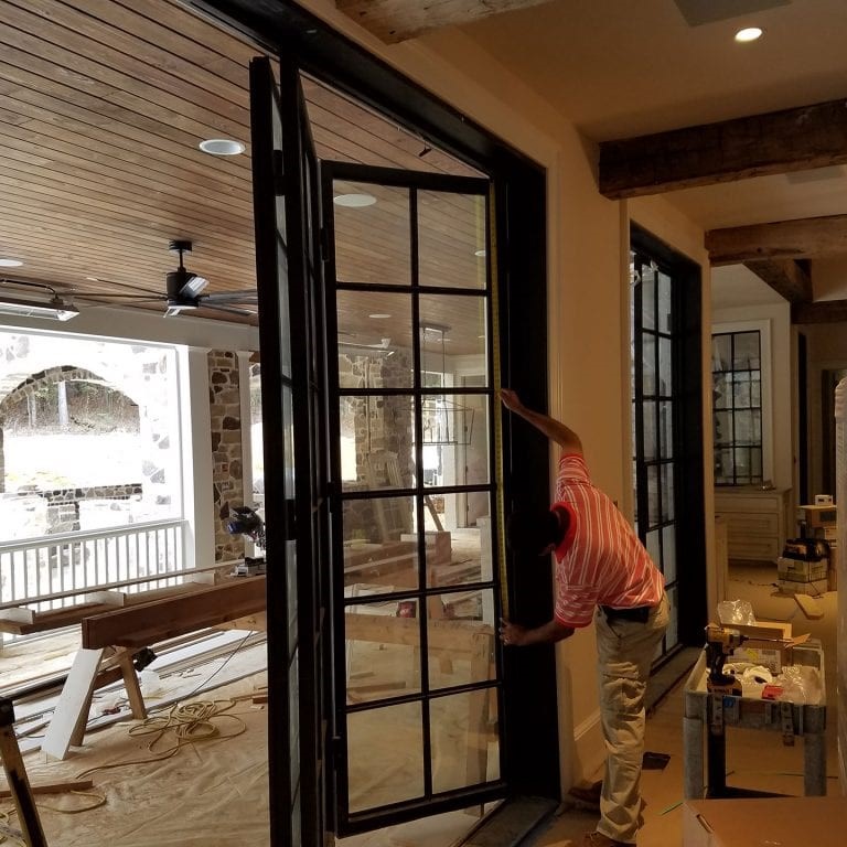 Worker installing French Steel doors